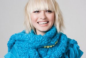Blonde woman with a cute bob wearing a blue scarf